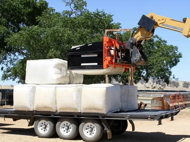 Tuskan with Soft Hands working beside wrapped bales